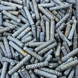 Close-up of a pile of blue cylindrical vintage ceramic beads with intricate patterns.
