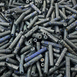 Close-up of a pile of dark blue cylindrical vintage ceramic beads with intricate patterns.