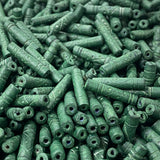 Close-up of a pile of green cylindrical vintage ceramic beads with intricate patterns.