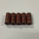 Five cylindrical old ceramic beads with decorative elements on a white background