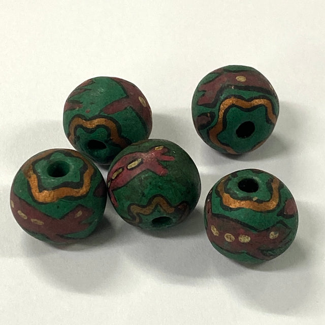 Five green and brown patterned vintage ceramic beads with lizards on a white background