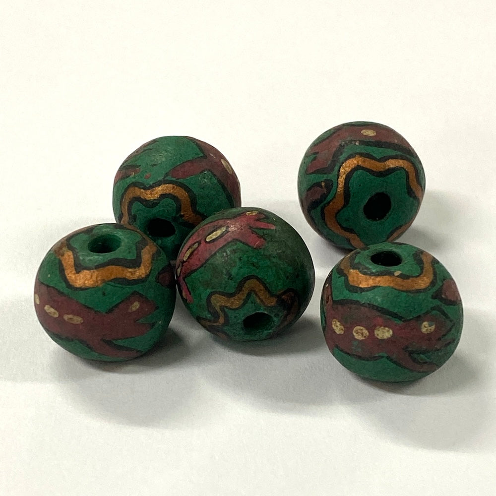 Five green and brown vintage ceramic patterned beads on a white background
