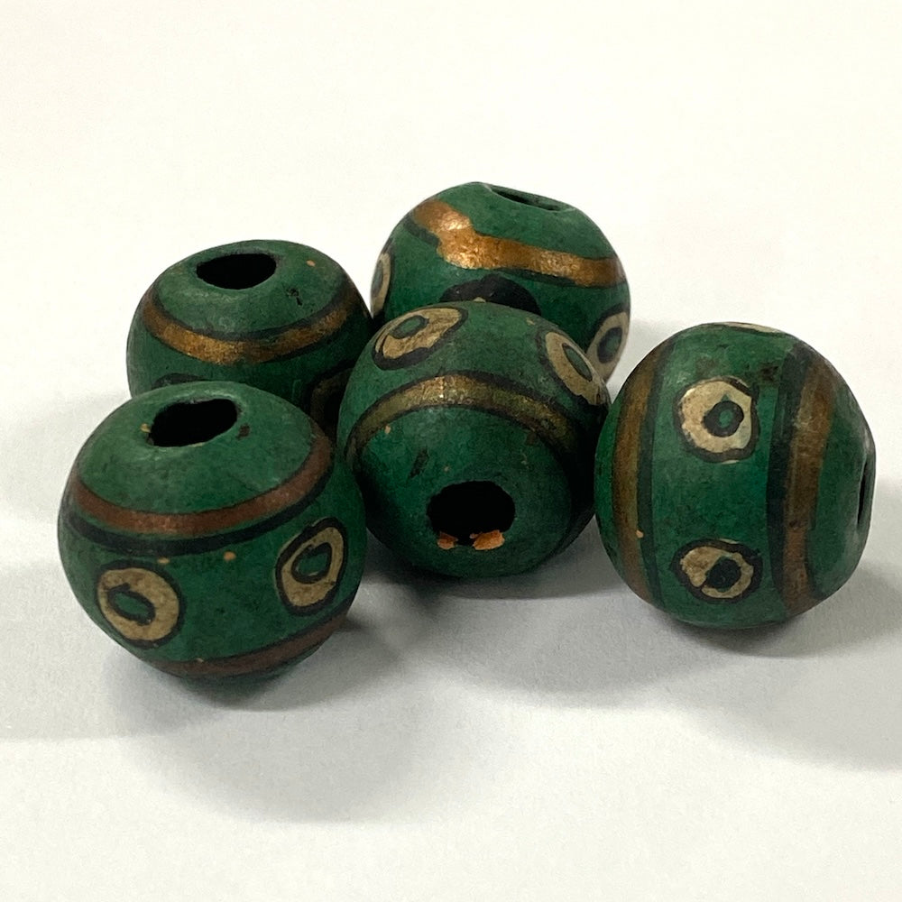 Green vintage ceramic beads with gold accents on a white background