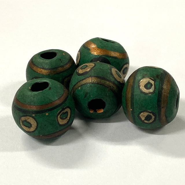 Green vintage ceramic beads with gold accents on a white background
