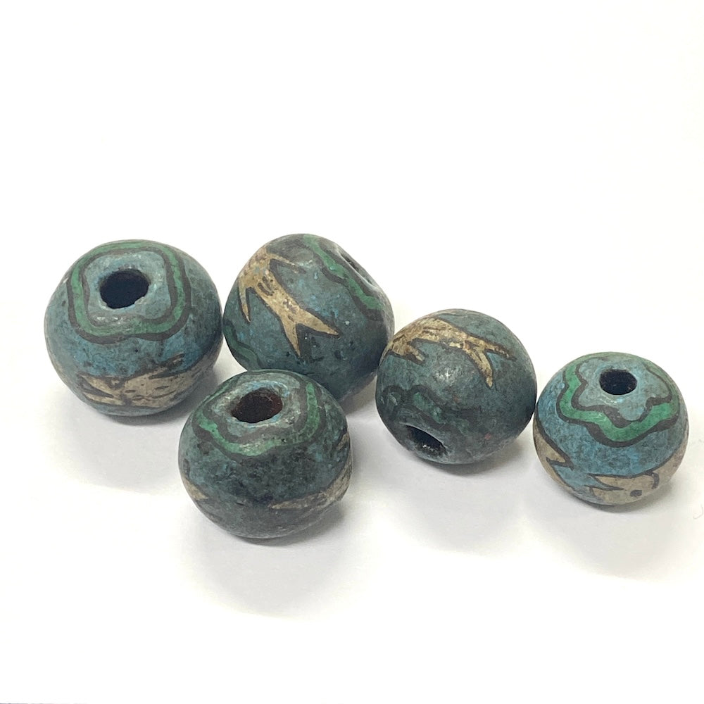 Five green and brown marbled beads on a white background