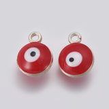 Two red evil eye charms with silver borders on a white background