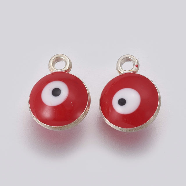 Two red evil eye charms with silver borders on a white background