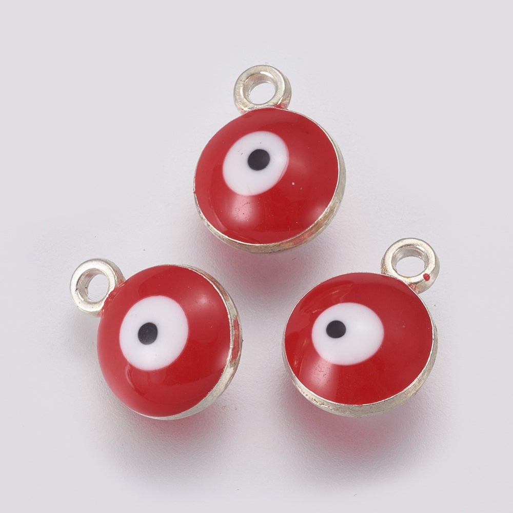 Three red evil eye charms with silver loops on a white background