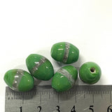 Green beads with silver stripes on a white background, measured against a ruler.