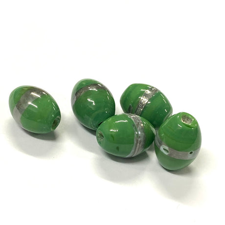 Green oval beads with silver accents on a white background
