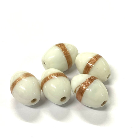 Five white oval beads with gold stripes on a white background