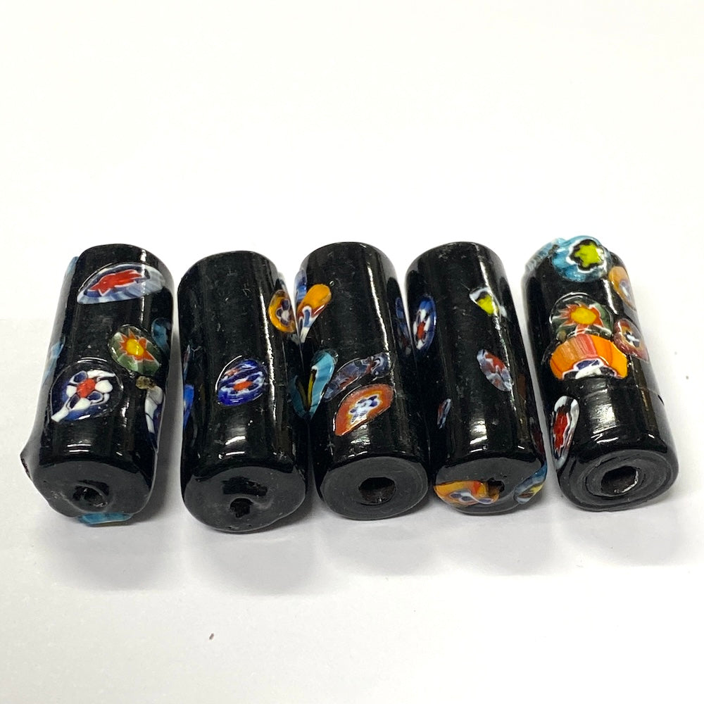 Set of six black cylindrical beads with colorful designs on a white background