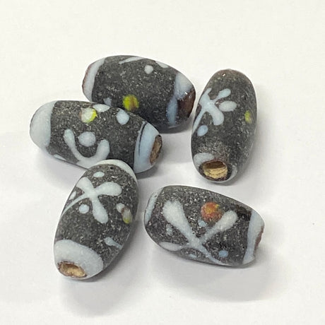 Set of dark gray beads with white patterns on a white background