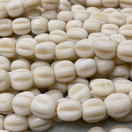 Close-up of white beads with a textured surface