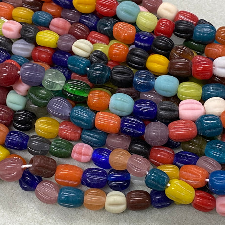 Colorful glass beads on a textured surface