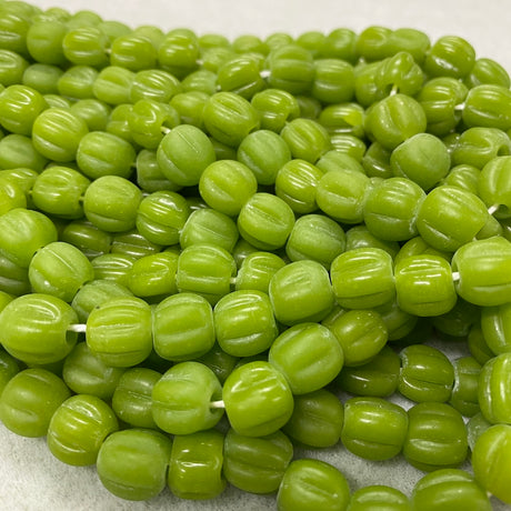 Close-up of green beads on a white background