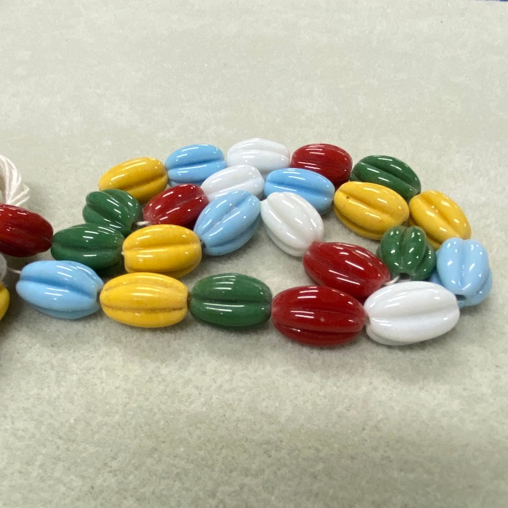 Colorful glass beads on a textured surface