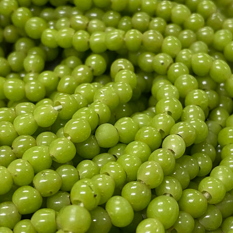 Close-up of small green beads on a string