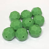 faceted green crystal beads on a white background
