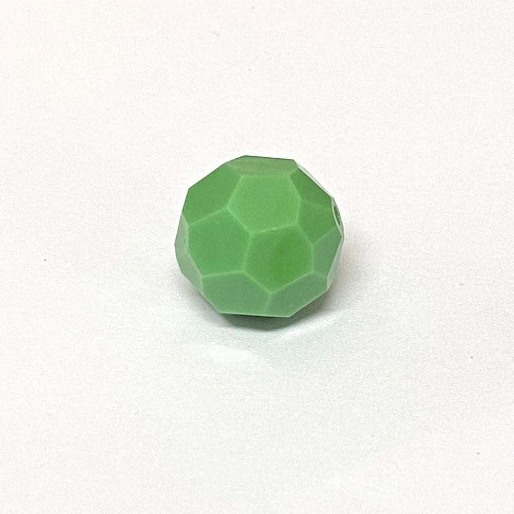 faceted green crystal bead on a white background