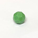 faceted green crystal bead on a white background
