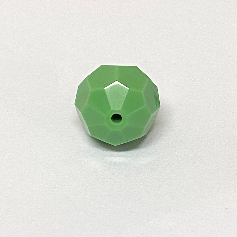 faceted green crystal bead on a white background