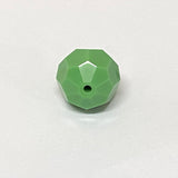 faceted green crystal bead on a white background