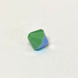 faceted green crystal bead on a white background