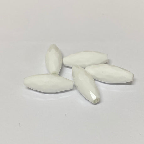 white faceted crystal beads on a grey background