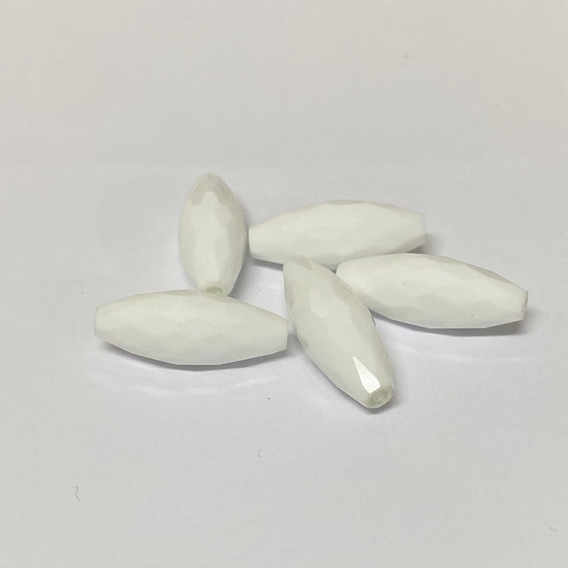 white faceted crystal beads on a grey background