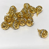 Group of gold and crystal pear shaped pendant beads on a white background