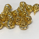 Group of gold and crystal pear shaped pendant beads on a white background