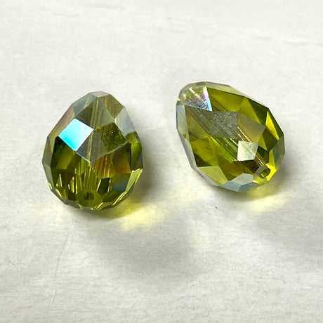 Green faceted crystal pear shape  bead on a white background