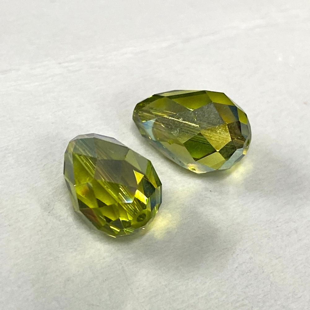 Green faceted crystal pear shape  bead on a white background
