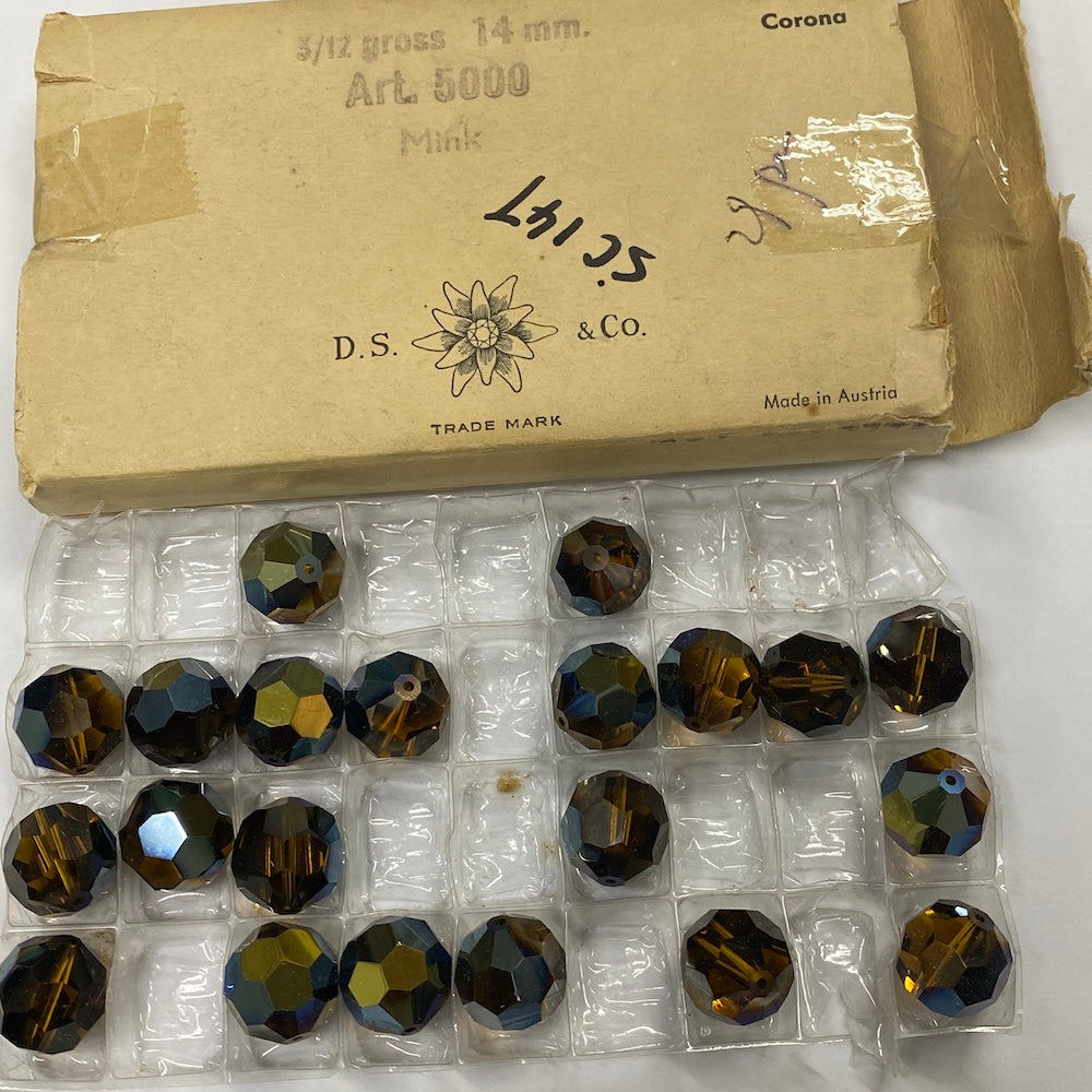 Box of faceted gemstones with D.S. & Co. branding on a white background