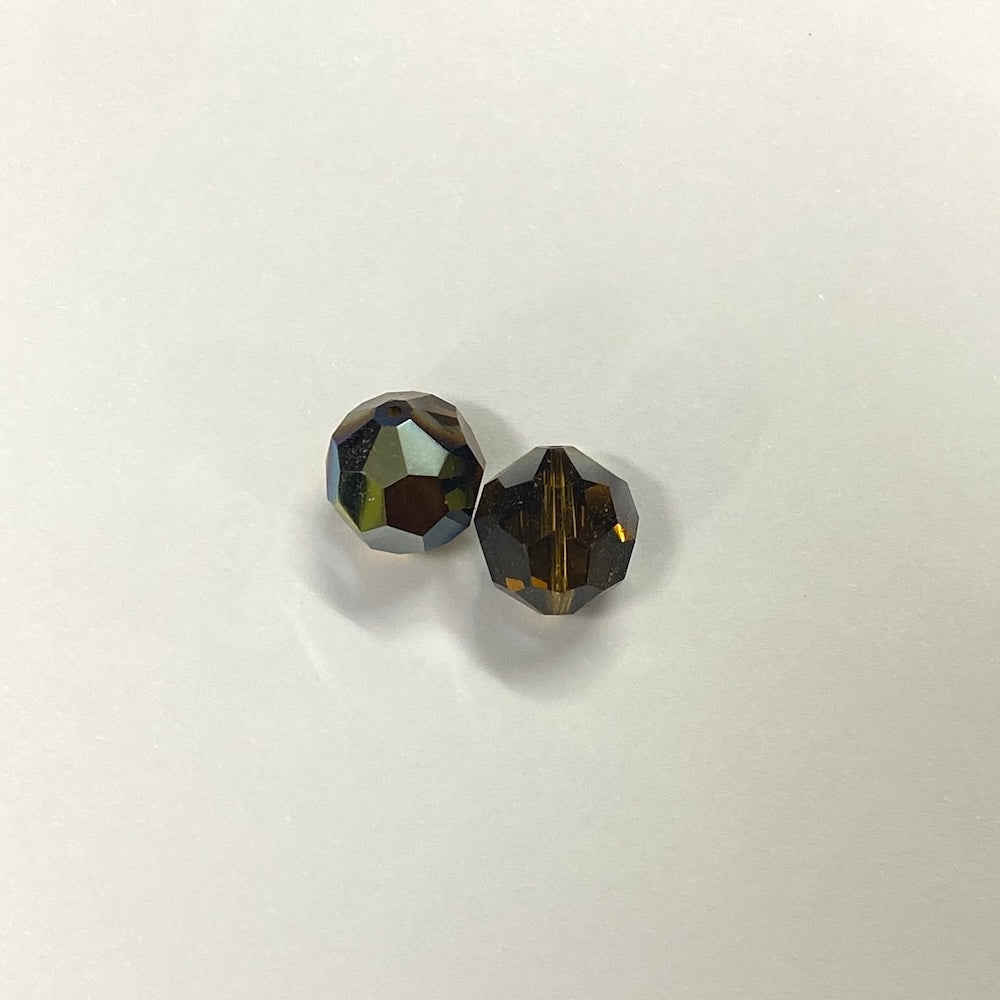 Two faceted brown crystal beads on a light gray background