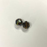 Two faceted brown crystal beads on a light gray background