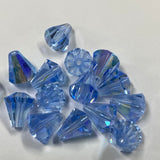 Blue faceted crystal bell shape beads on a white background