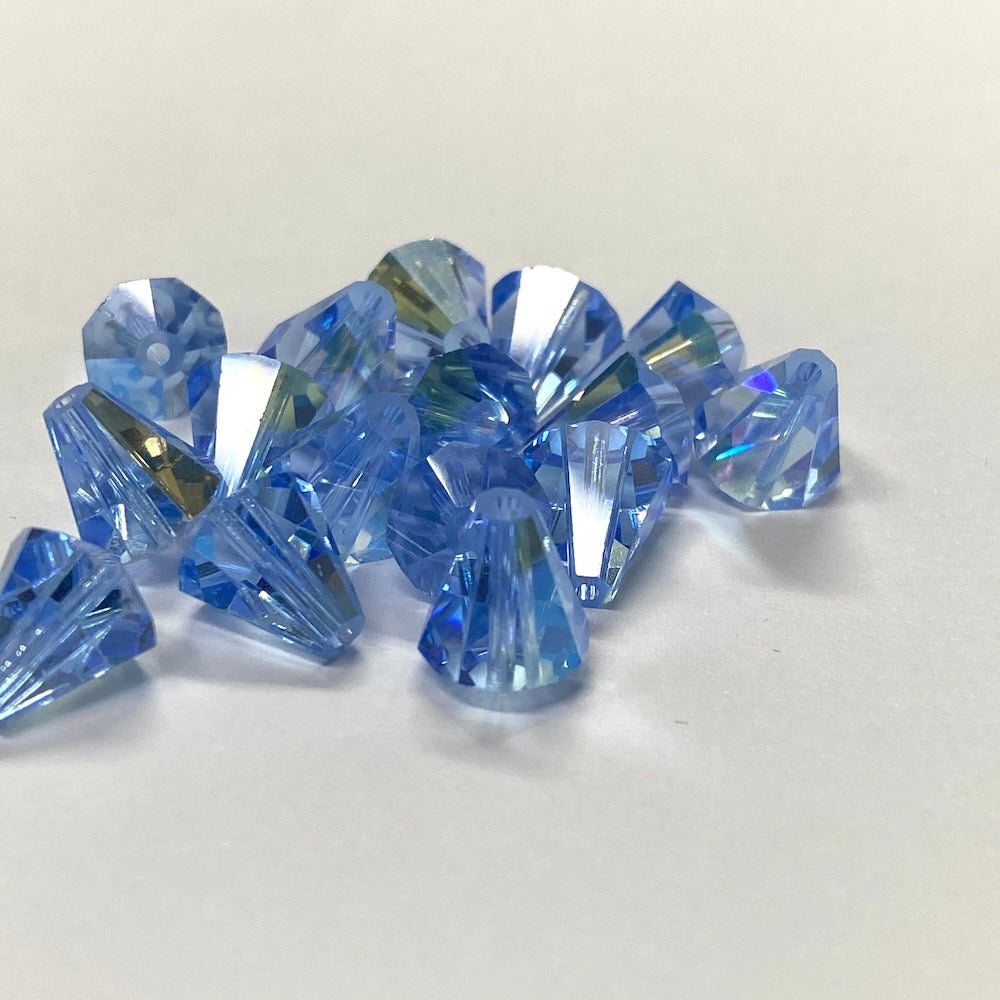 Blue faceted crystal bell shape beads on a white background