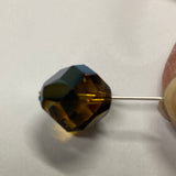Faceted brown crystal bead on a white background