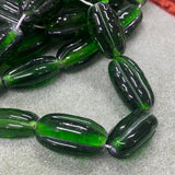 Green glass beads on a textured surface