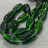Green glass beads on a gray surface