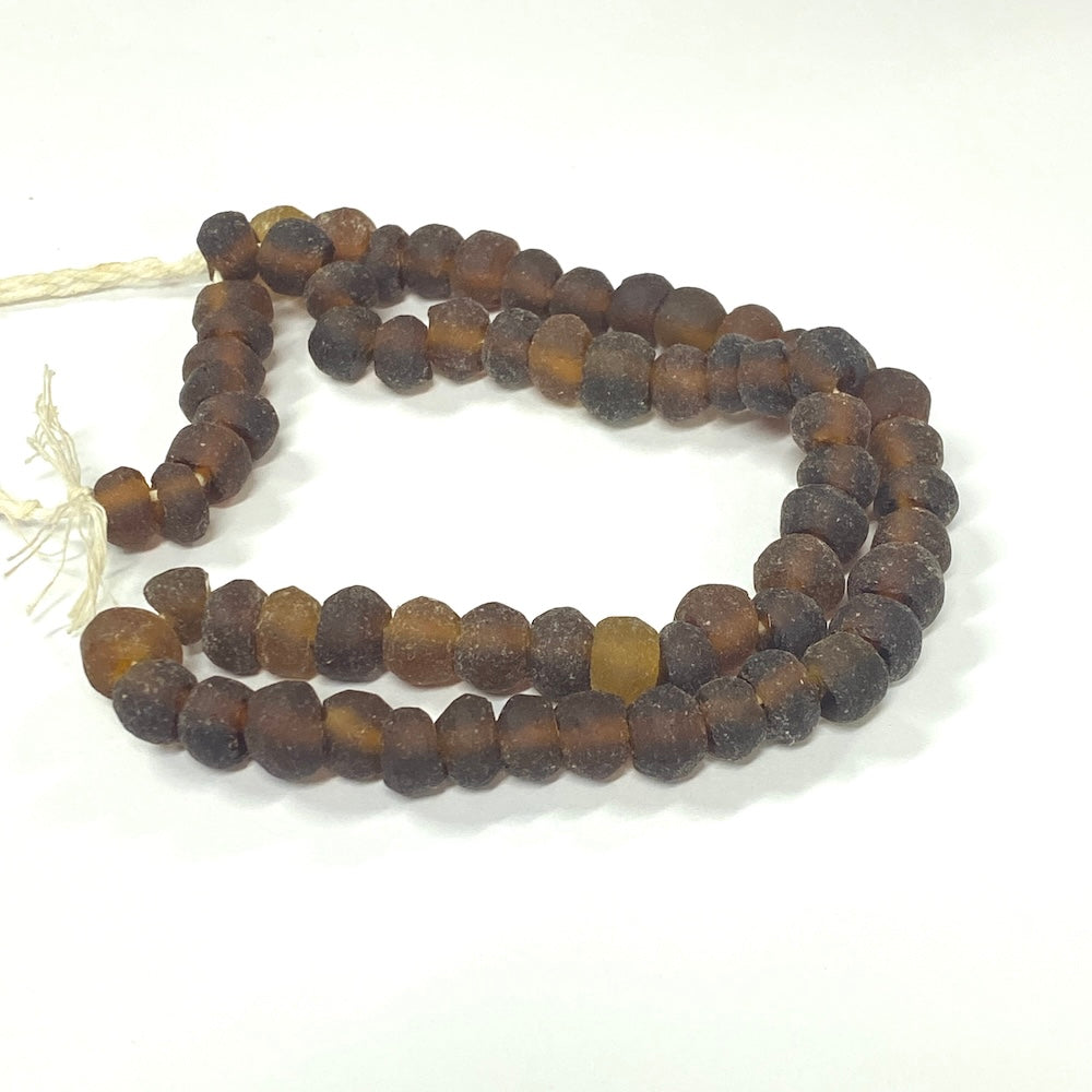 String of brown beads on a white background