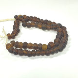 String of brown beads on a white background