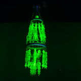 Green glowing vaseline vintage beads hanging decorative item against a black background