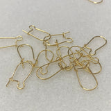gold metal ear fittings with a closure on the back with a grey background