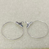 Pair of silver hoop earrings on a light gray background