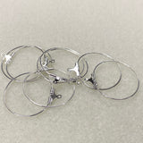 Set of silver hoop earrings on a light gray background