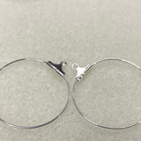 Silver hoop earrings on a light gray background