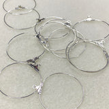 Silver hoop earrings on a light gray background
